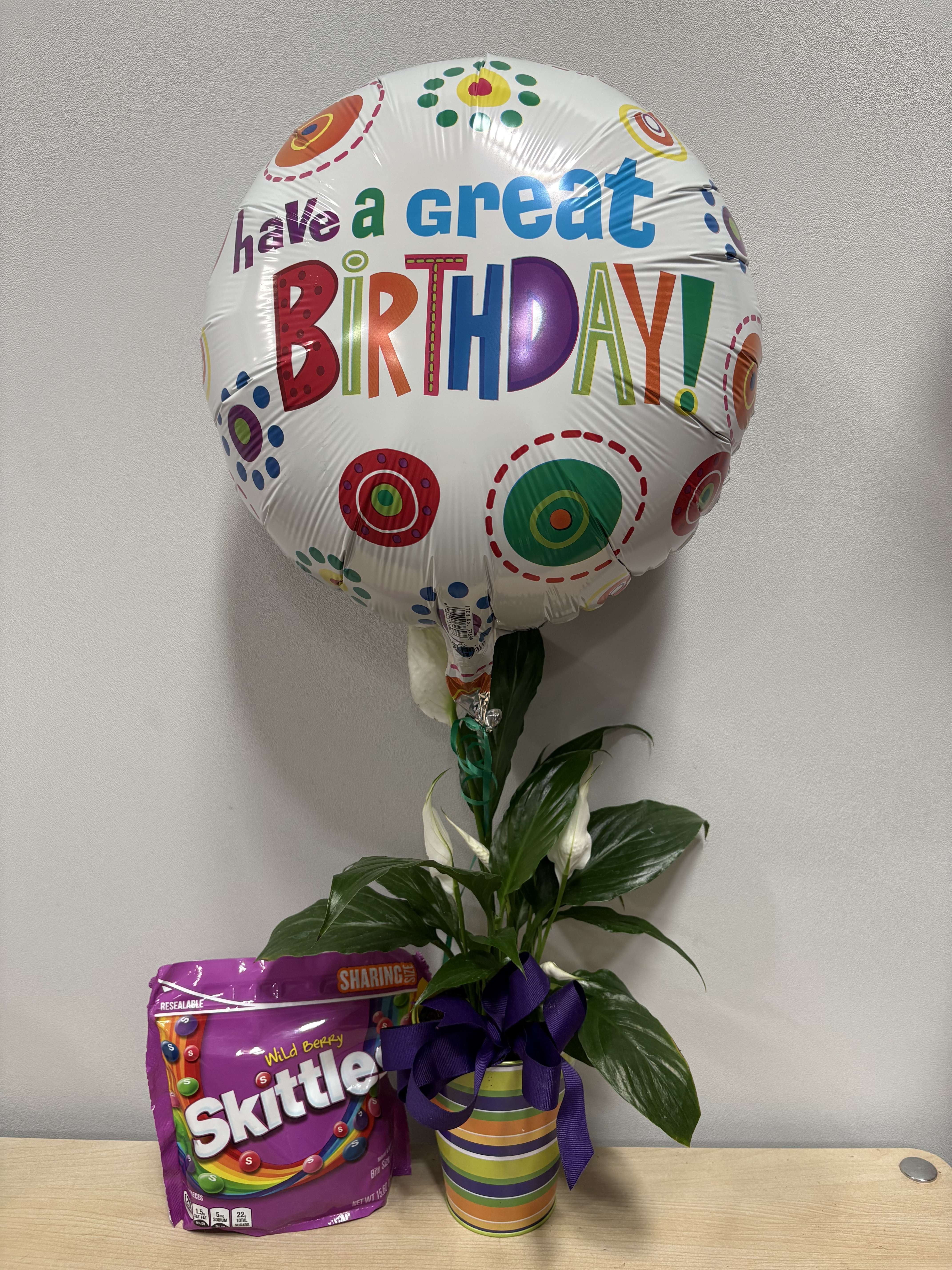 Birthday balloon with a potted plant and candy bag