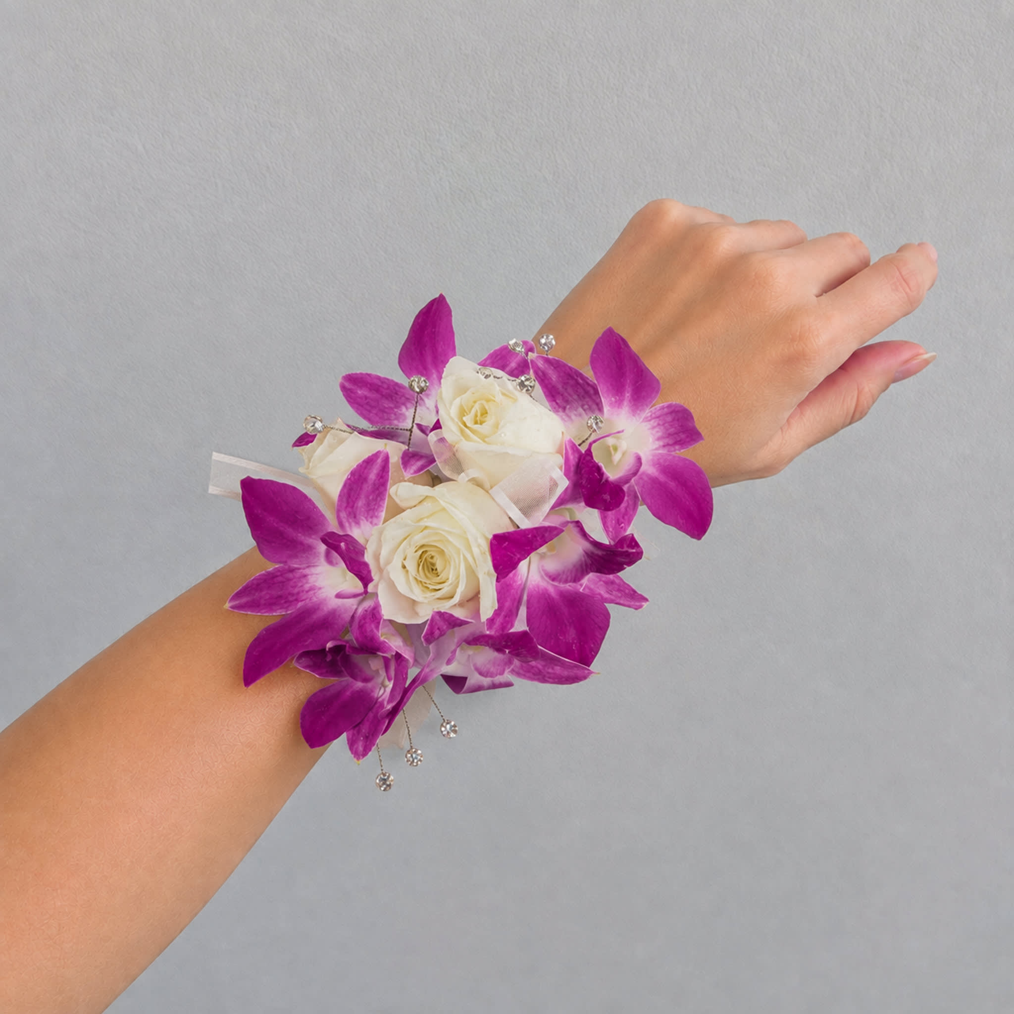 Wrist corsage with white roses and purple orchids