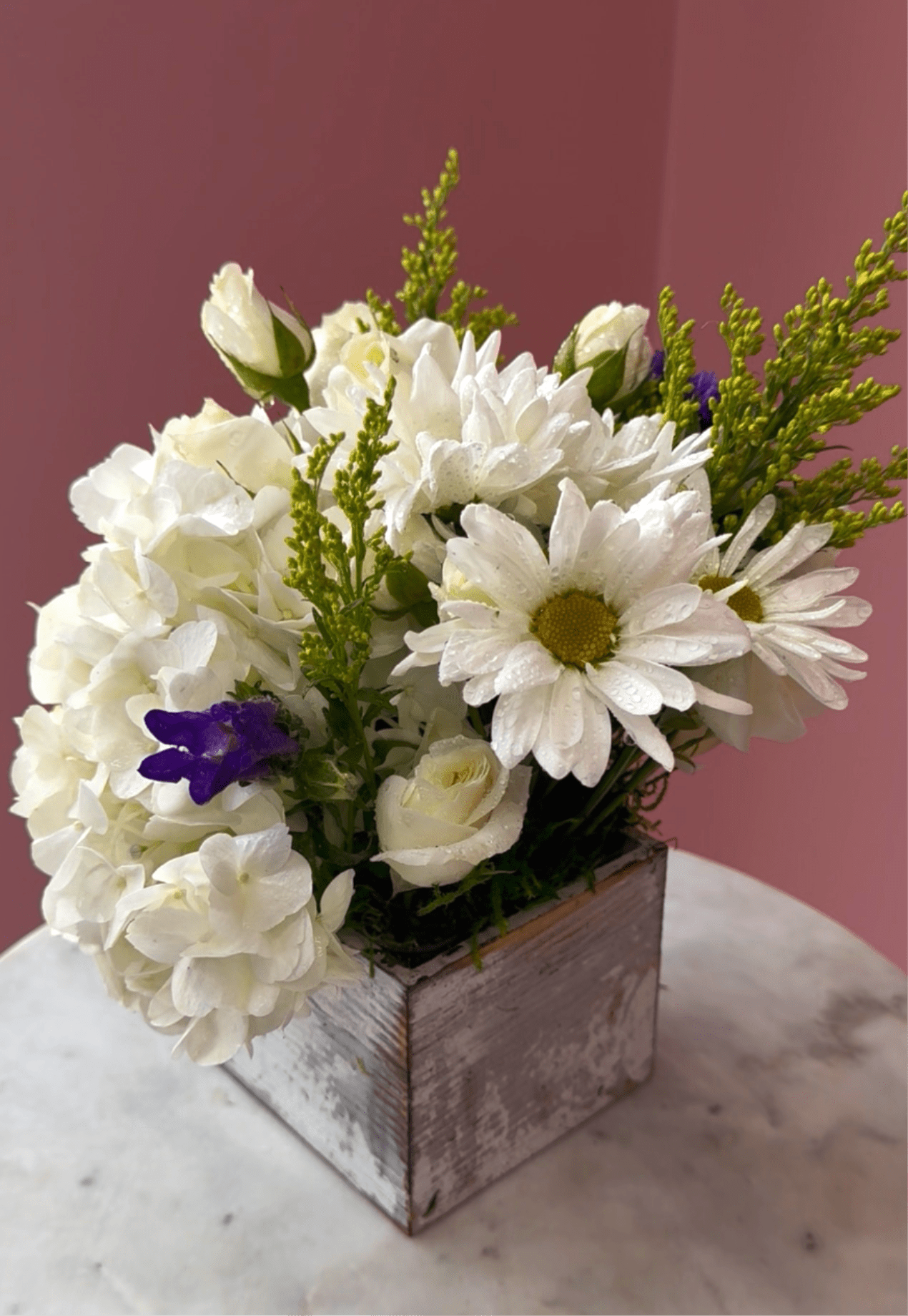 Breath of Fresh Air by Evergreen Elegance  - This is the perfect gift for someone who can use some R &amp; R. The arrangement contains roses, carnations, blue iris, and other seasonal blooms. APPROXIMATE DIMENSIONS: 8" L x 8" W x 8" H