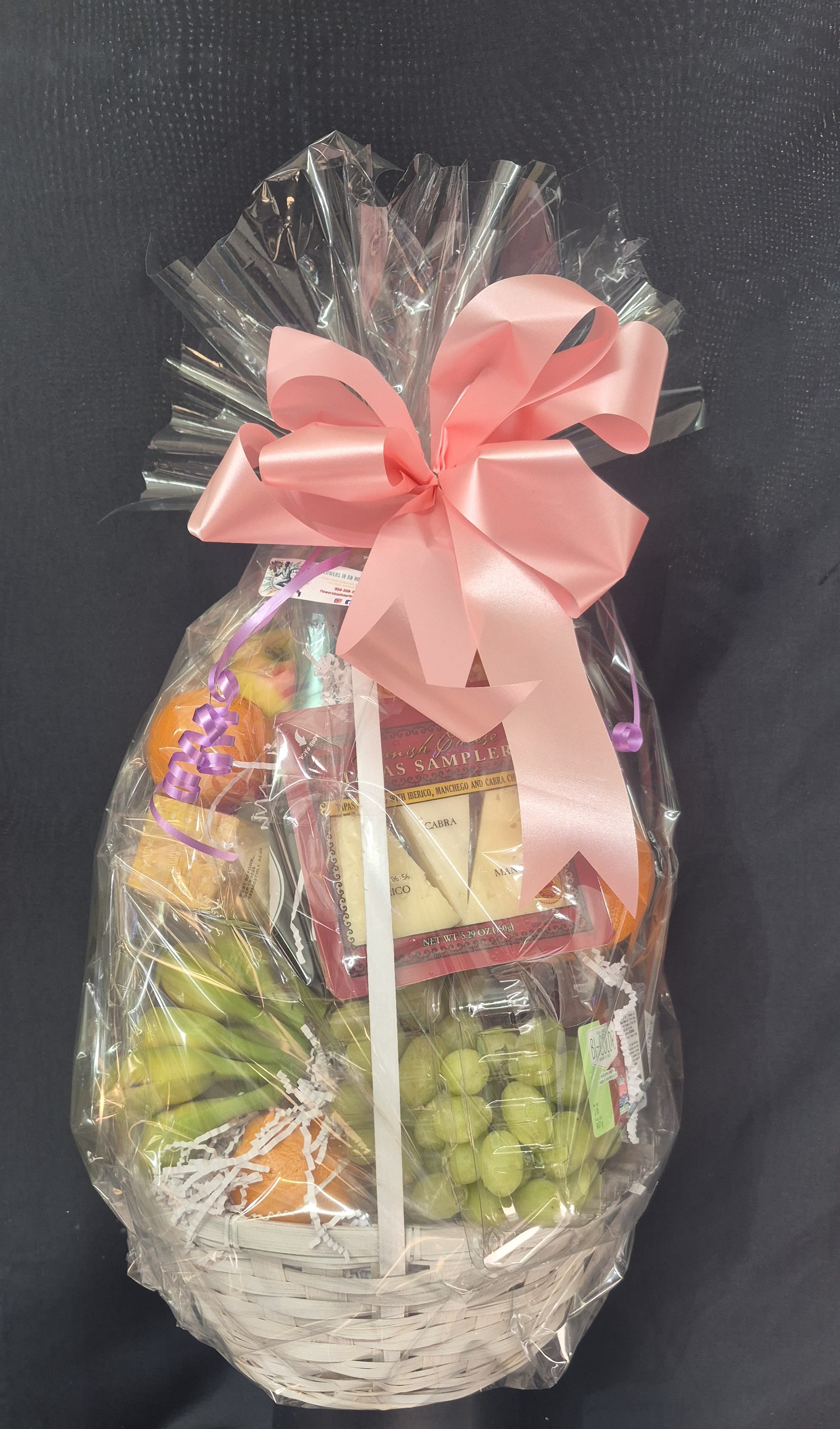 SWEET COMFORT FRUIT AND GOURMET BASKET - A beautifully arranged basket of fresh seasonal fruit paired with a gourmet cheese sampler, gourmet chocolates, cookies, jams/honey  and other thoughtful indulgence worthy of ones palate. This gift is perfect for expressing sympathy, celebrating a birthday, or simply letting someone know you're thinking of them. A testeful and nourishing gesture suitable for any occasion. (ribbon color to match the occasion) 