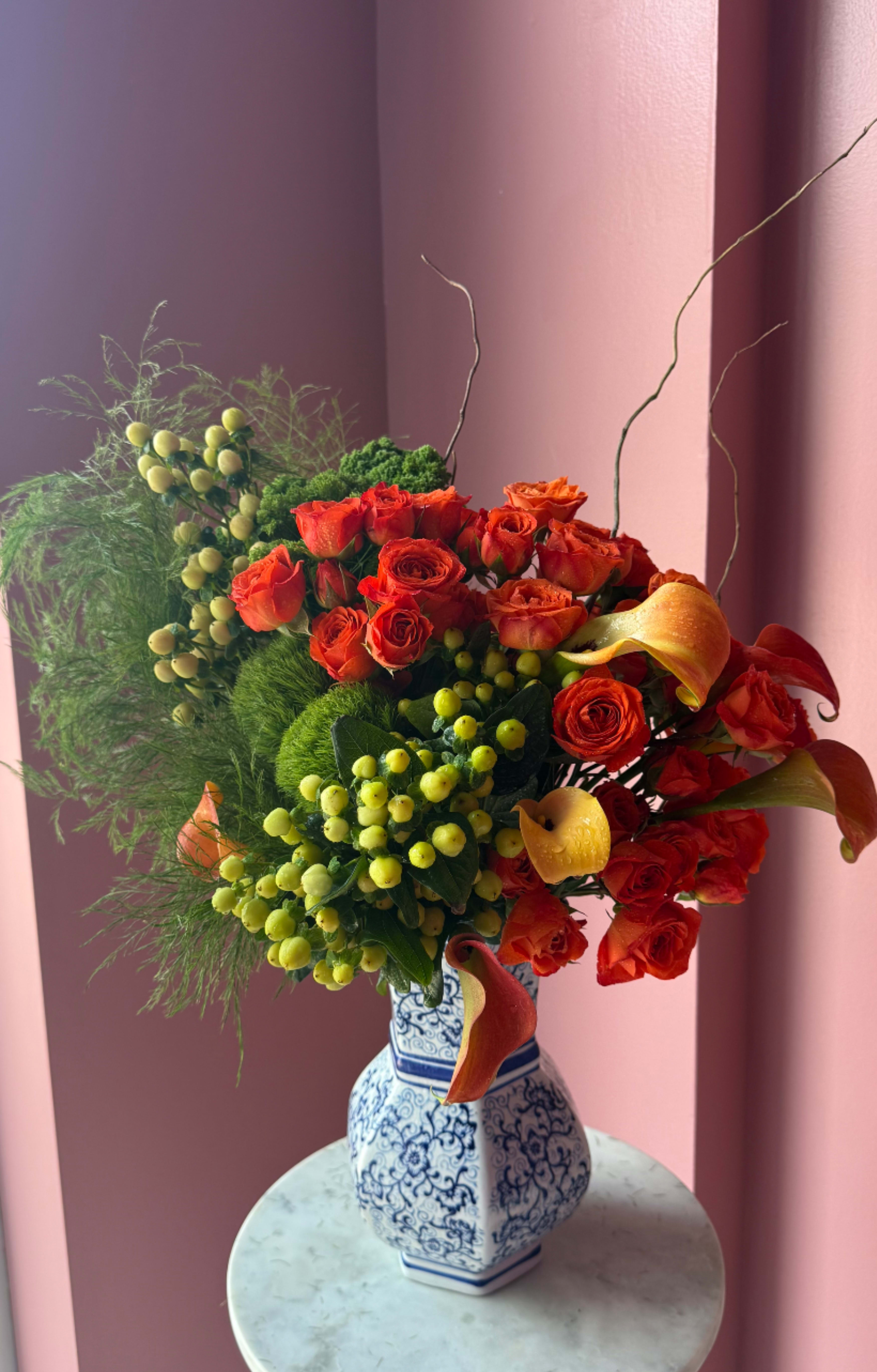 Autumn Chic by Evergreen Elegance  - Autumn glimmer is a quintessential fall arrangement featuring a gold architecture vase and a variety of fun fall flowers and accents. This arrangement is pure fun and elegance with a vase that the recipient will surely re-use. Send this to impress! Perfect for the autumn equinox, Halloween or Thanksgiving.  Approximate Dimensions: 16"D x 25"H