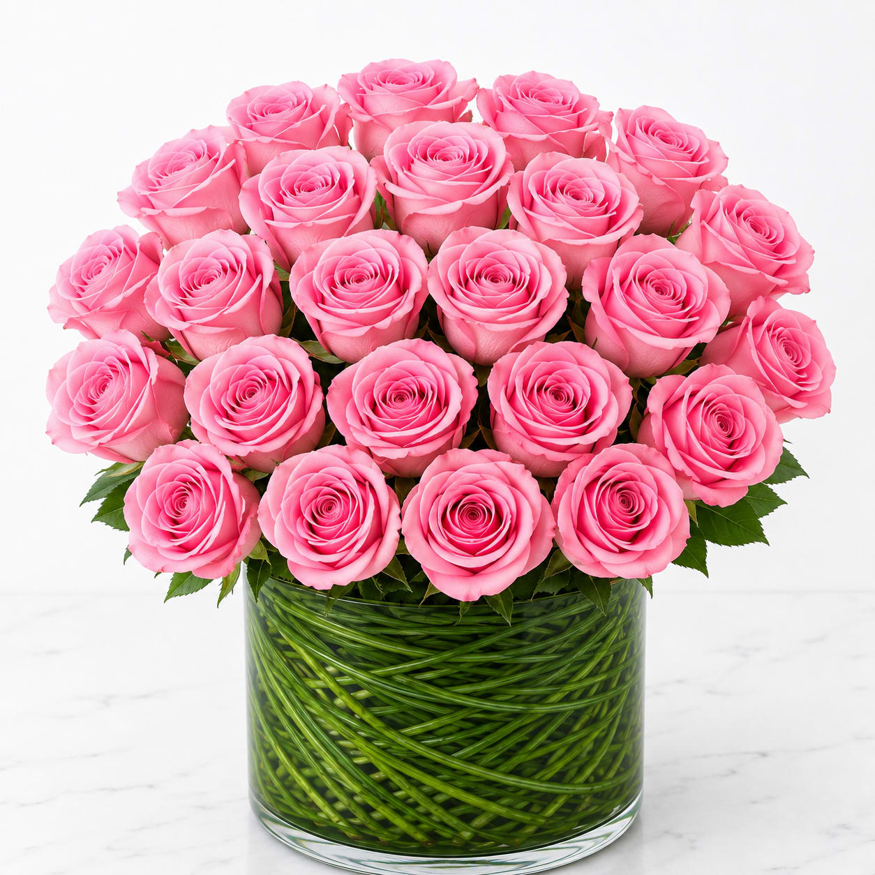 Pink roses arranged in a clear glass vase