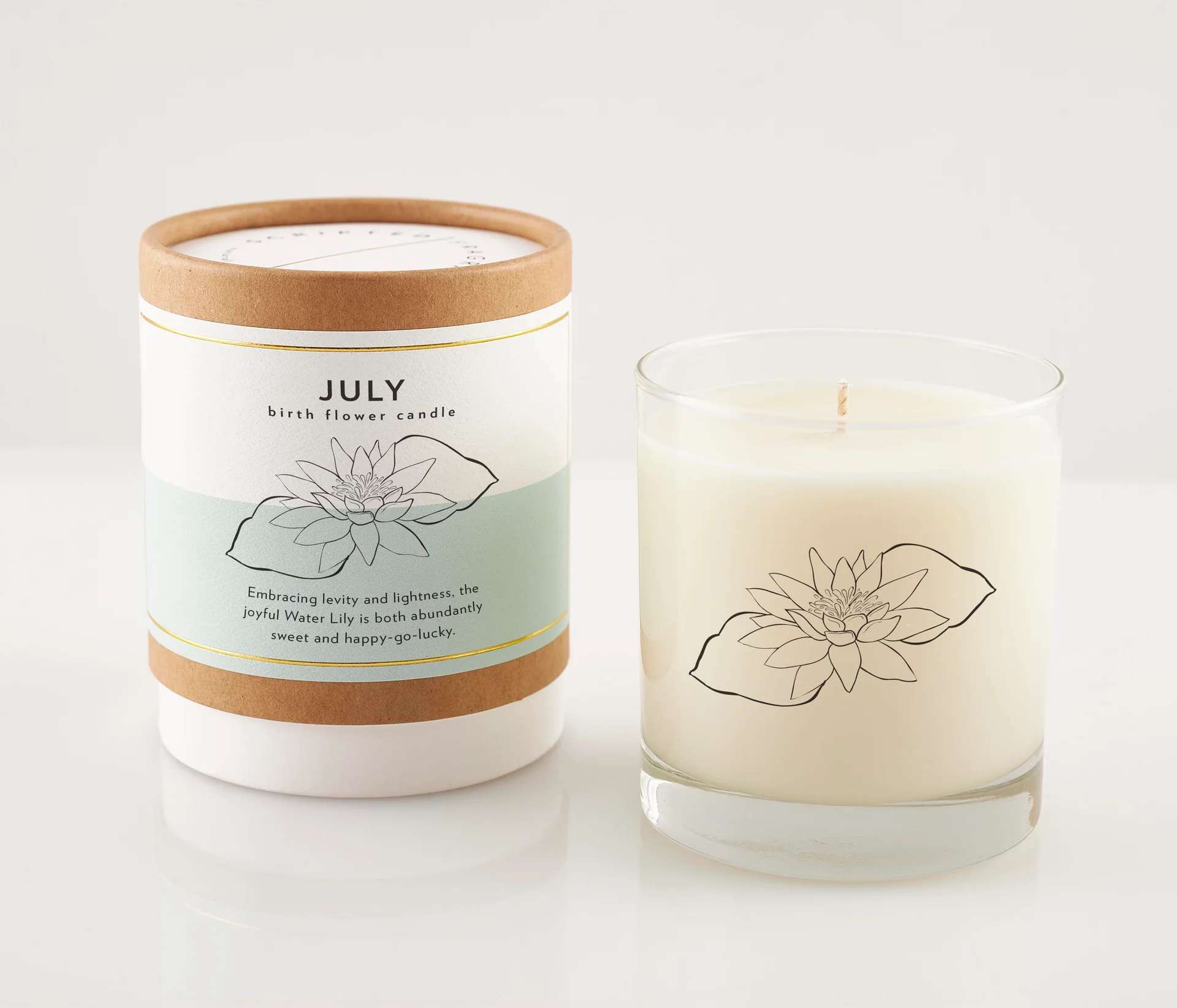 Two lily-themed candles, one in a labeled box and one in a glass jar