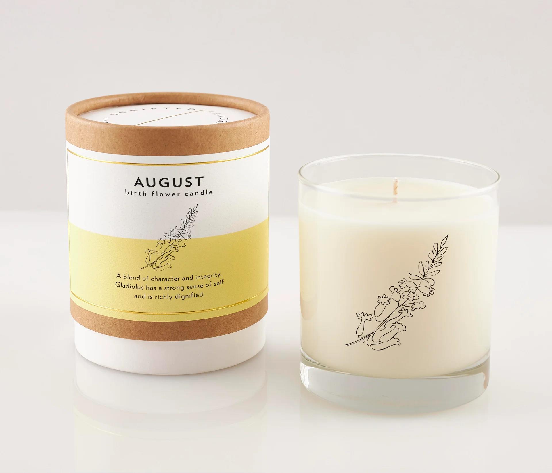 Two birth flower candles, one in a labeled box and one in a glass jar