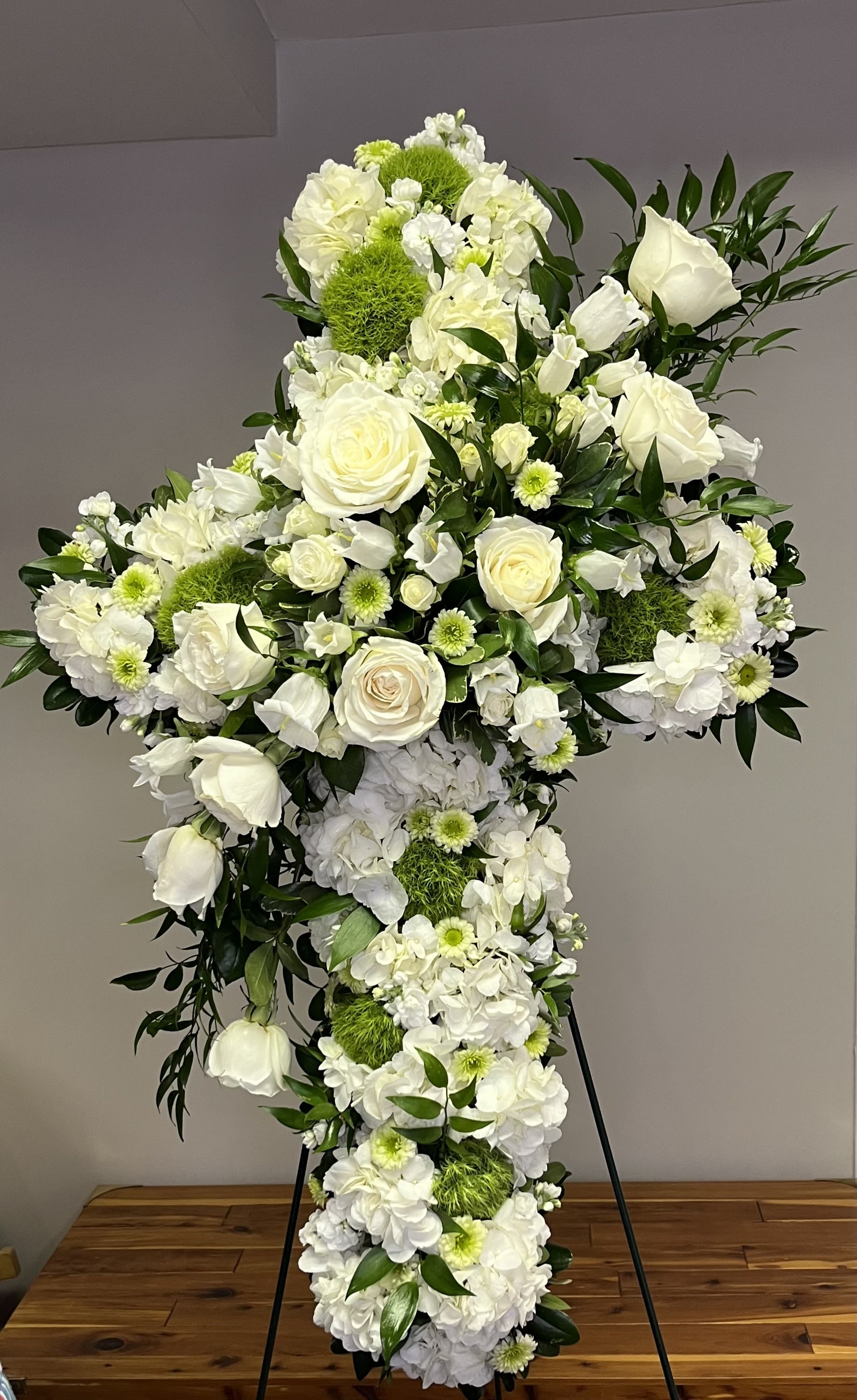 Faith and Comfort by Chasing Petals - Sending love and comfort through faith with this elegant cross. White and green flowers with a spray through the center will convey peace and comfort through faith.