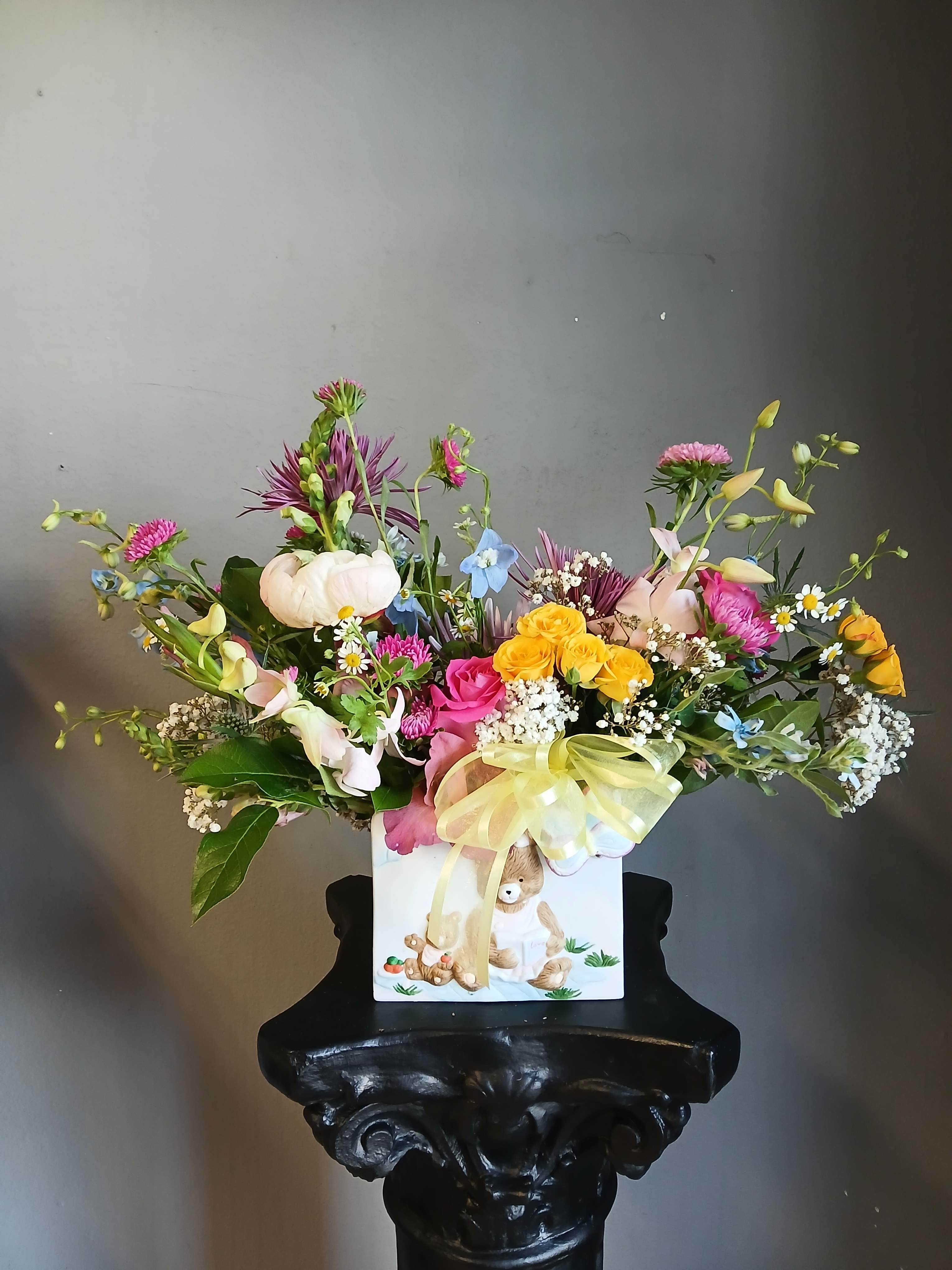 Colorful mixed bouquet in a white gift box with a yellow ribbon