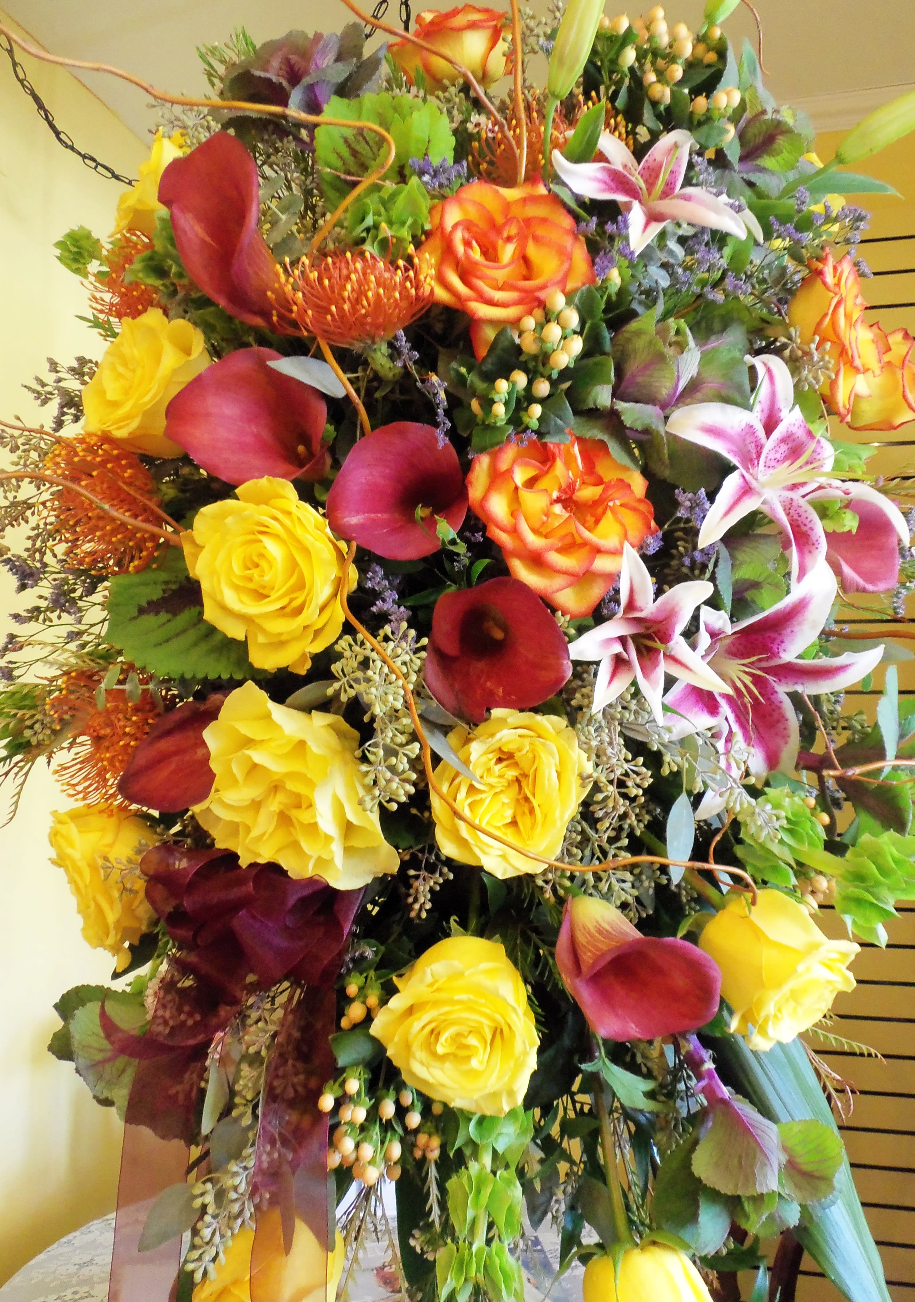 Large bouquet with yellow roses, burgundy calla lilies, and pink lilies