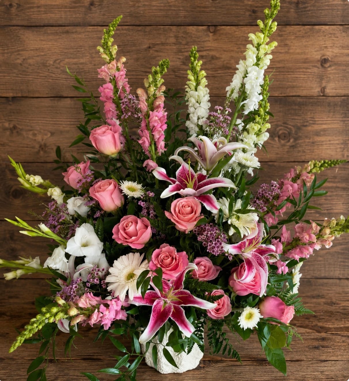 Pink and white mixed flower arrangement in a white vase