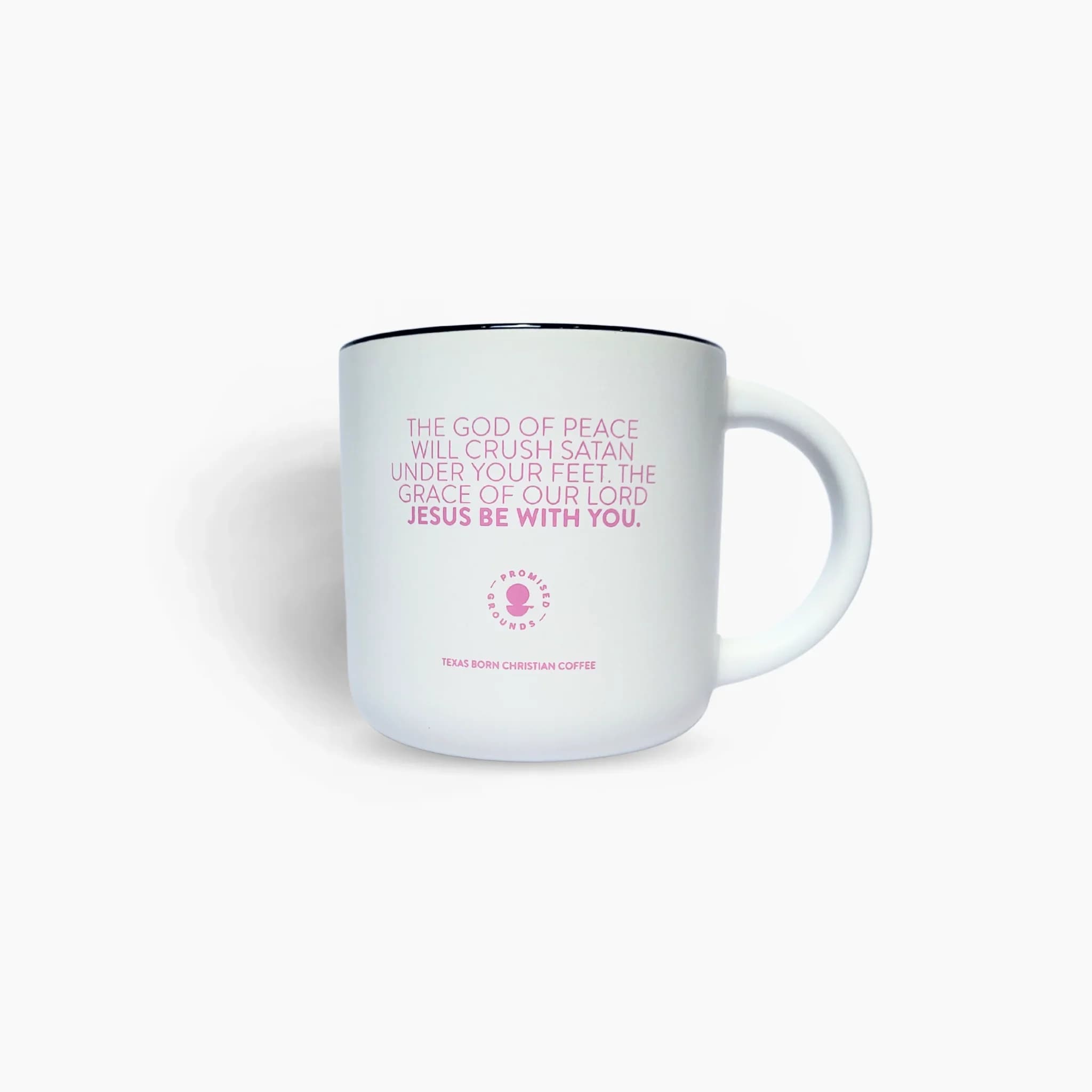 White mug with pink religious text and a black rim