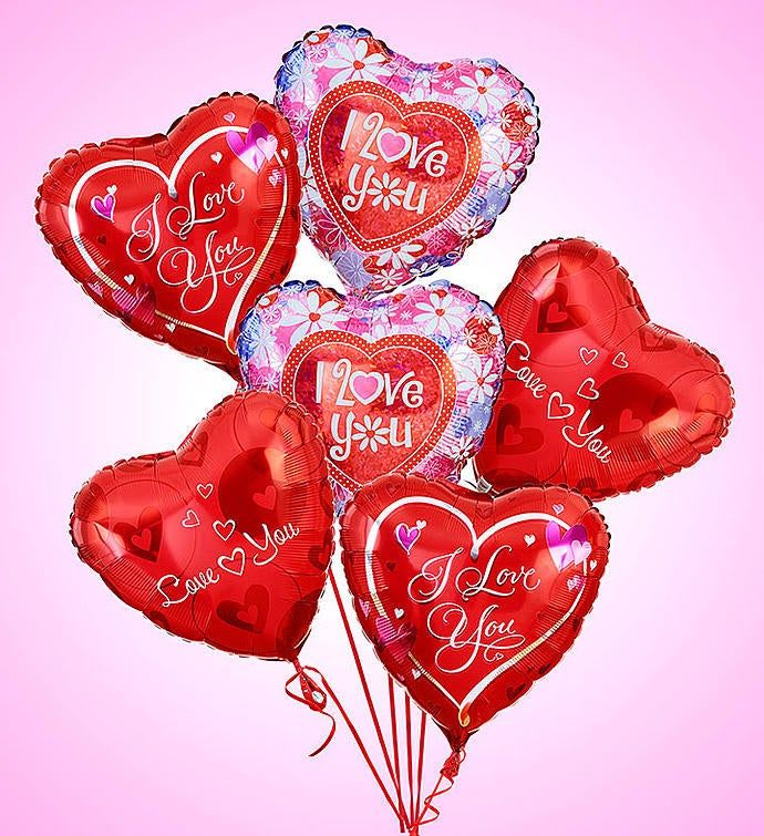 Cluster of heart-shaped red and pink balloons with love messages