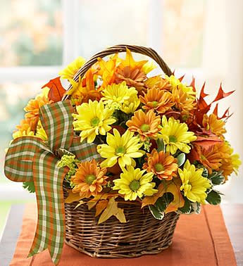 Fall Daisy Basket - Product ID: 90829  Bring back childhood memories of days spent picking fresh flowers. Our charming Autumn arrangement is filled with cheerful yellow and bronze daisies, hand-designed in a rustic handled basket. For birthdays, anniversaries, housewarmings or âjust becauseâ, it will make anyone smile just like theyâre a kid again! Yellow and bronze daisy poms, gathered by our select florists with fresh solidago, variegated pittosporum, fall leaves and a gorgeous ribbon Arranged in a handled willow basket; Our florists hand-design each arrangement, so colors, varieties and container may vary due to local availability