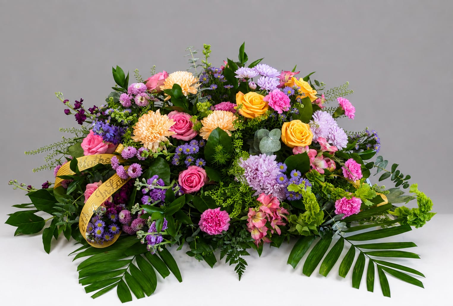 Large colorful floral arrangement with roses, chrysanthemums, and purple filler flowers