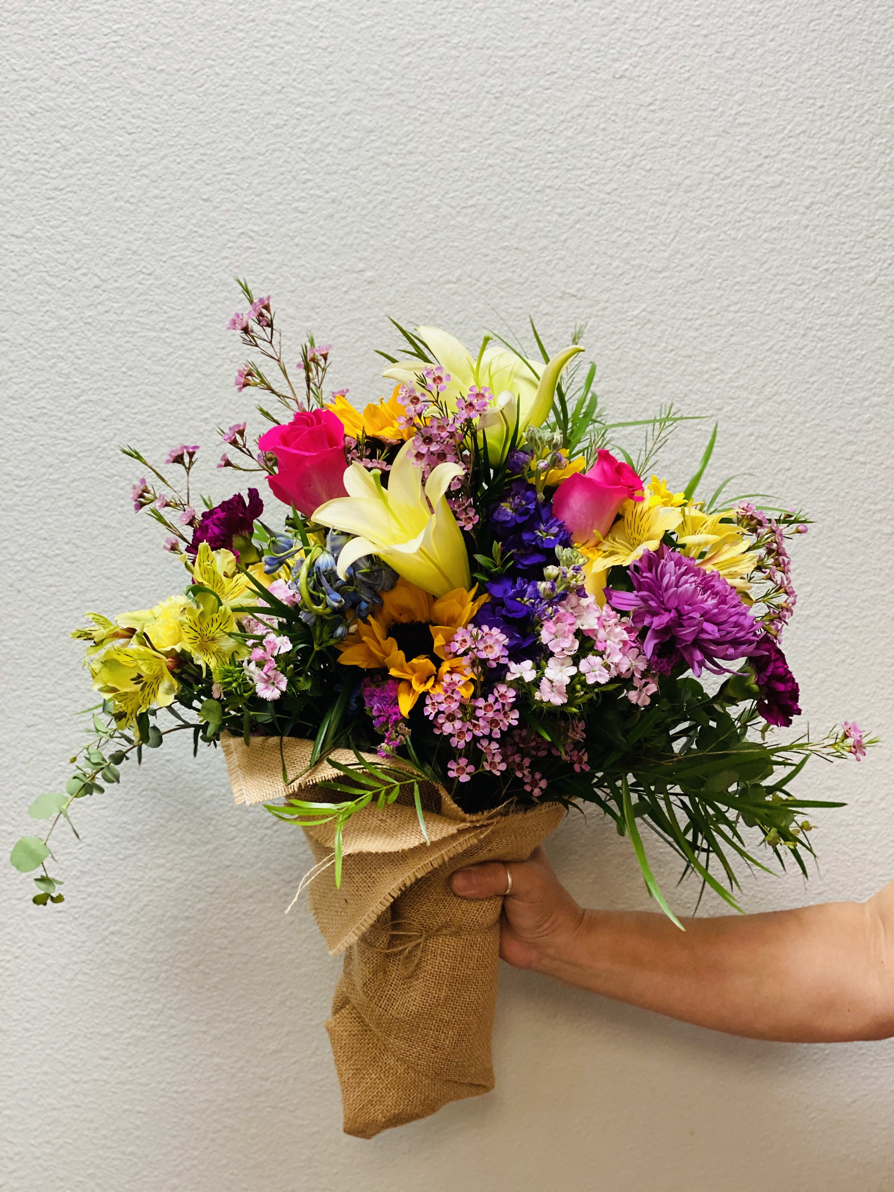 ENDLESS BLOOMS  - This hand-tied bouquet combines 30 stems of bright and cheerful blooms and foliage, and is wrapped up in biodegradable burlap! We use a fun mix of the highest quality flowers and design them into a “just picked from the garden” look.  Just to note: Pictures shown are recent examples of an actual hand-tied bouquet that we designed and later sent out to a customer just like you! Please note that your flowers will be the freshest seasonal assortment available and your special someone will love it!