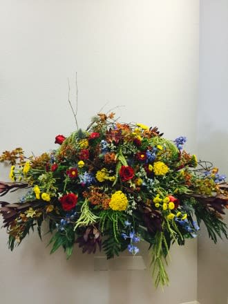 Large colorful floral arrangement with mixed blooms and greenery