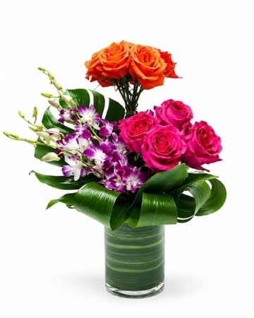Bouquet of orange and pink roses with purple orchids in a glass vase