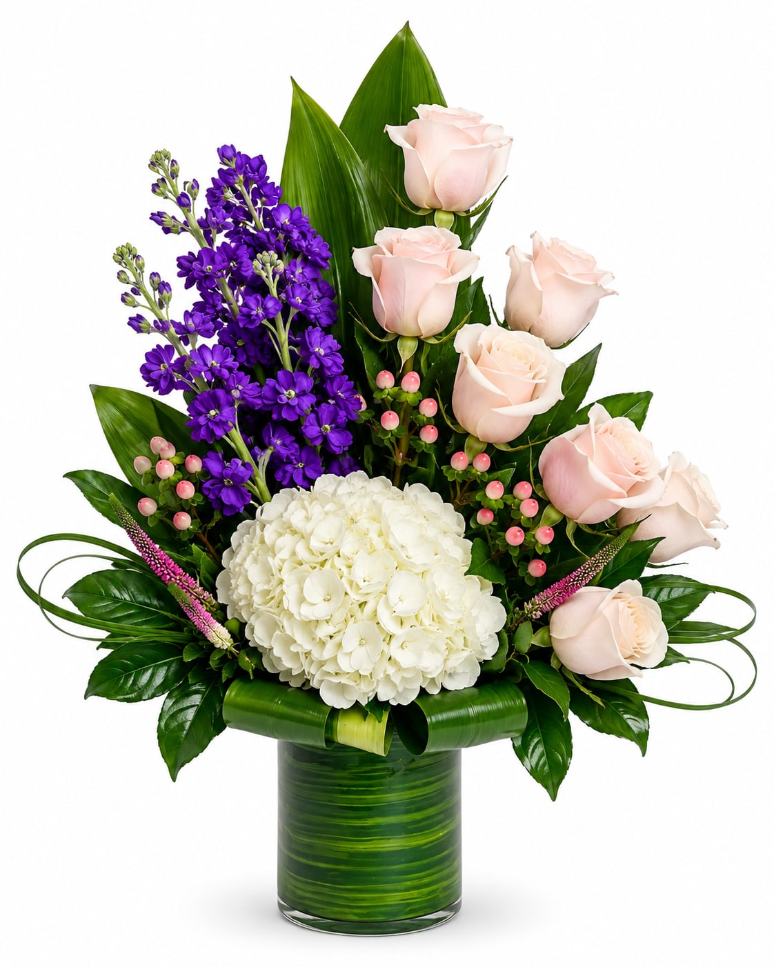 Pink roses and purple flowers in a green glass vase with white hydrangea