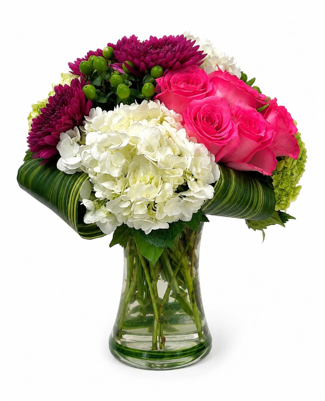 Bouquet of pink roses, white hydrangeas, and purple chrysanthemums in a glass vase