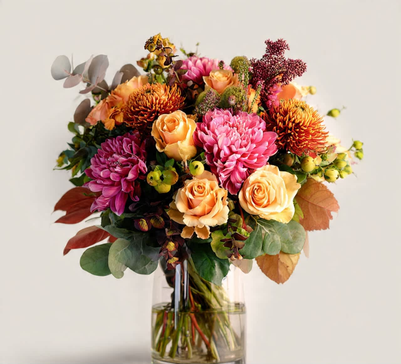 Bouquet of pink and peach flowers in a clear glass vase