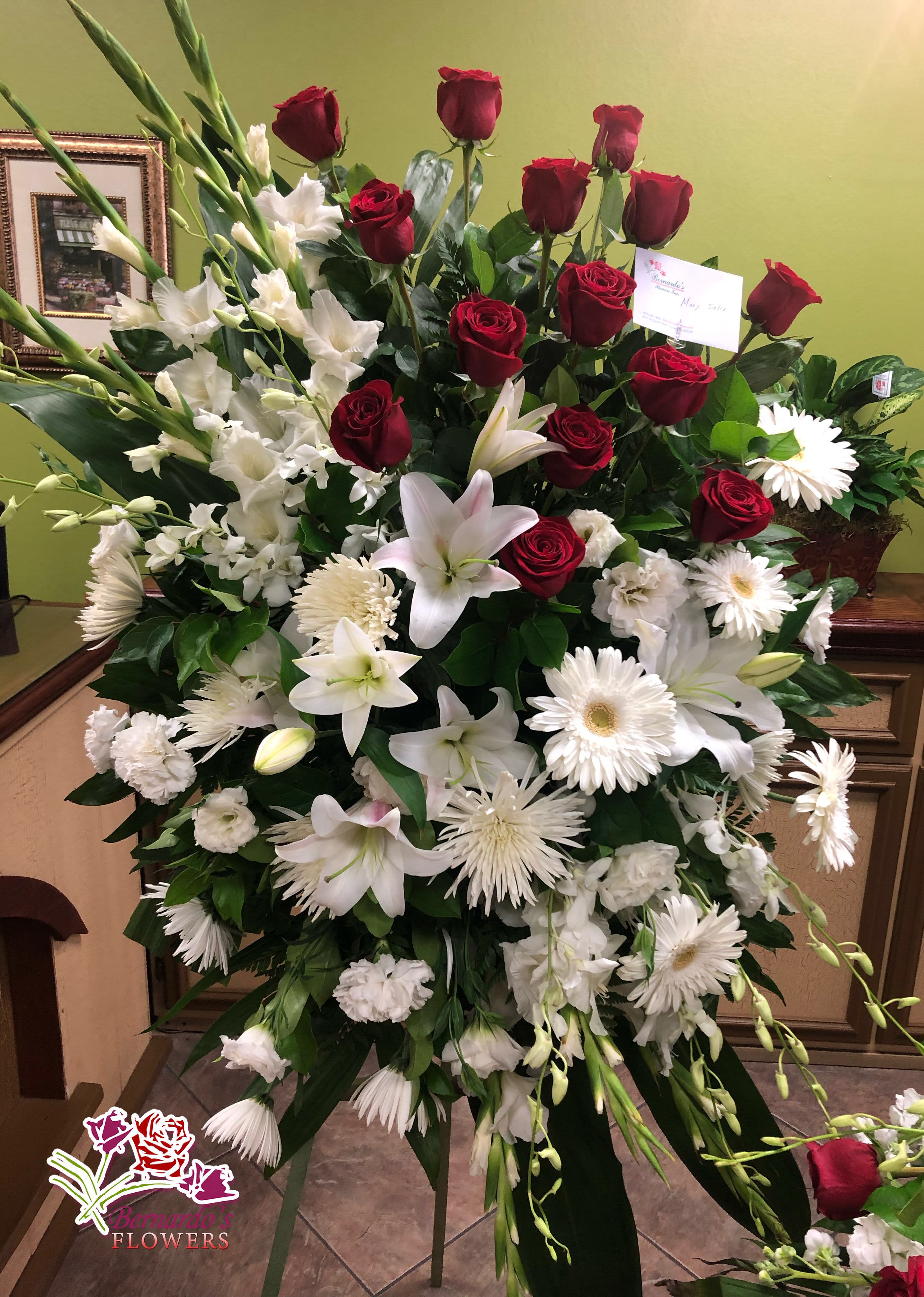 Large standing floral spray with red roses and white lilies