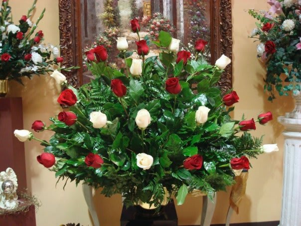 Large arrangement of red and white roses in a vase