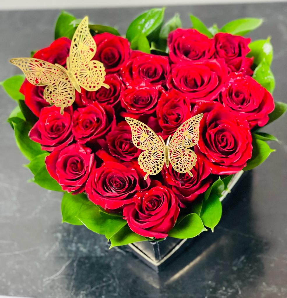Heart-shaped bouquet of red roses with gold butterfly accents
