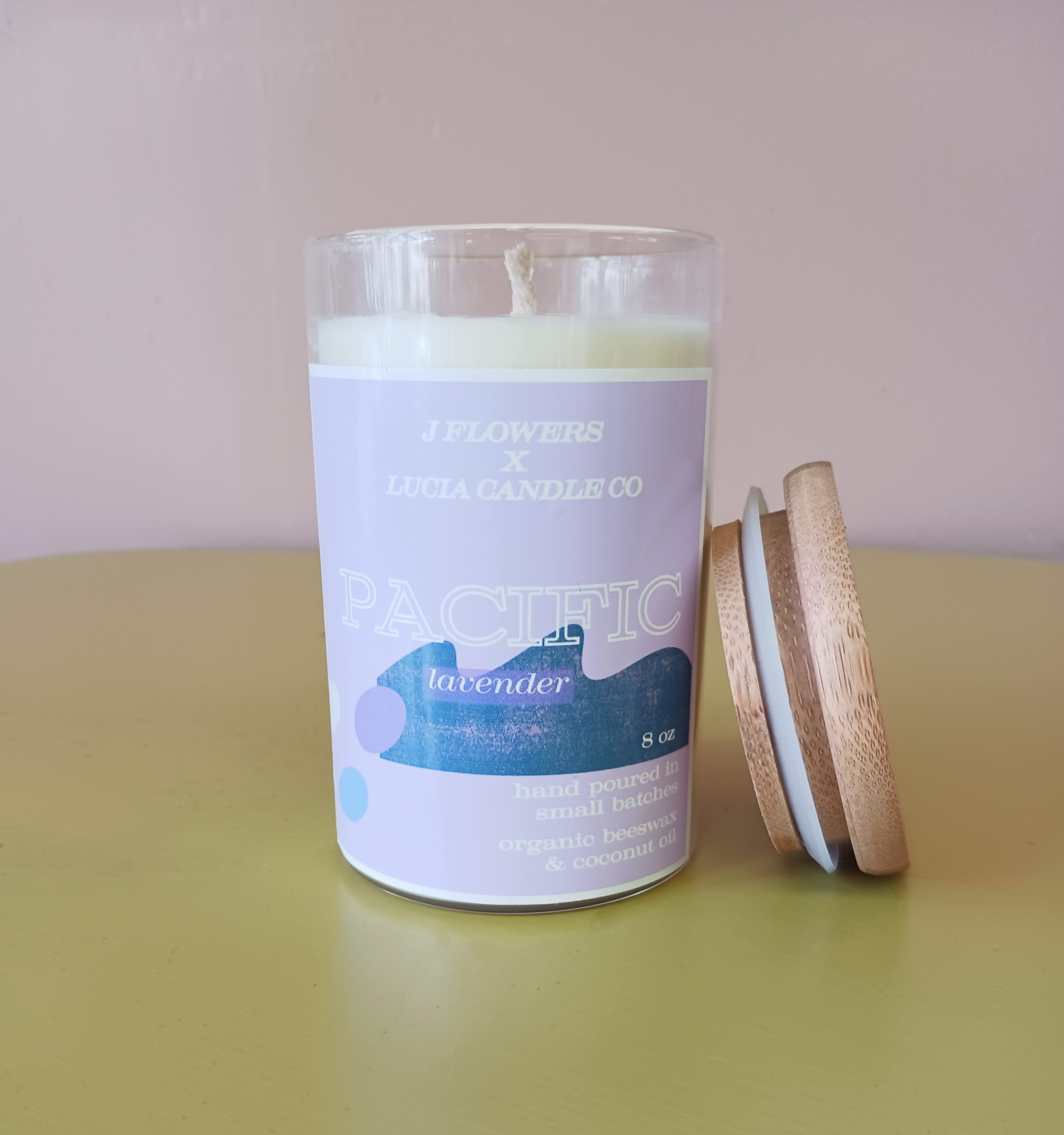 Lavender candle in a glass jar with a wooden lid beside it