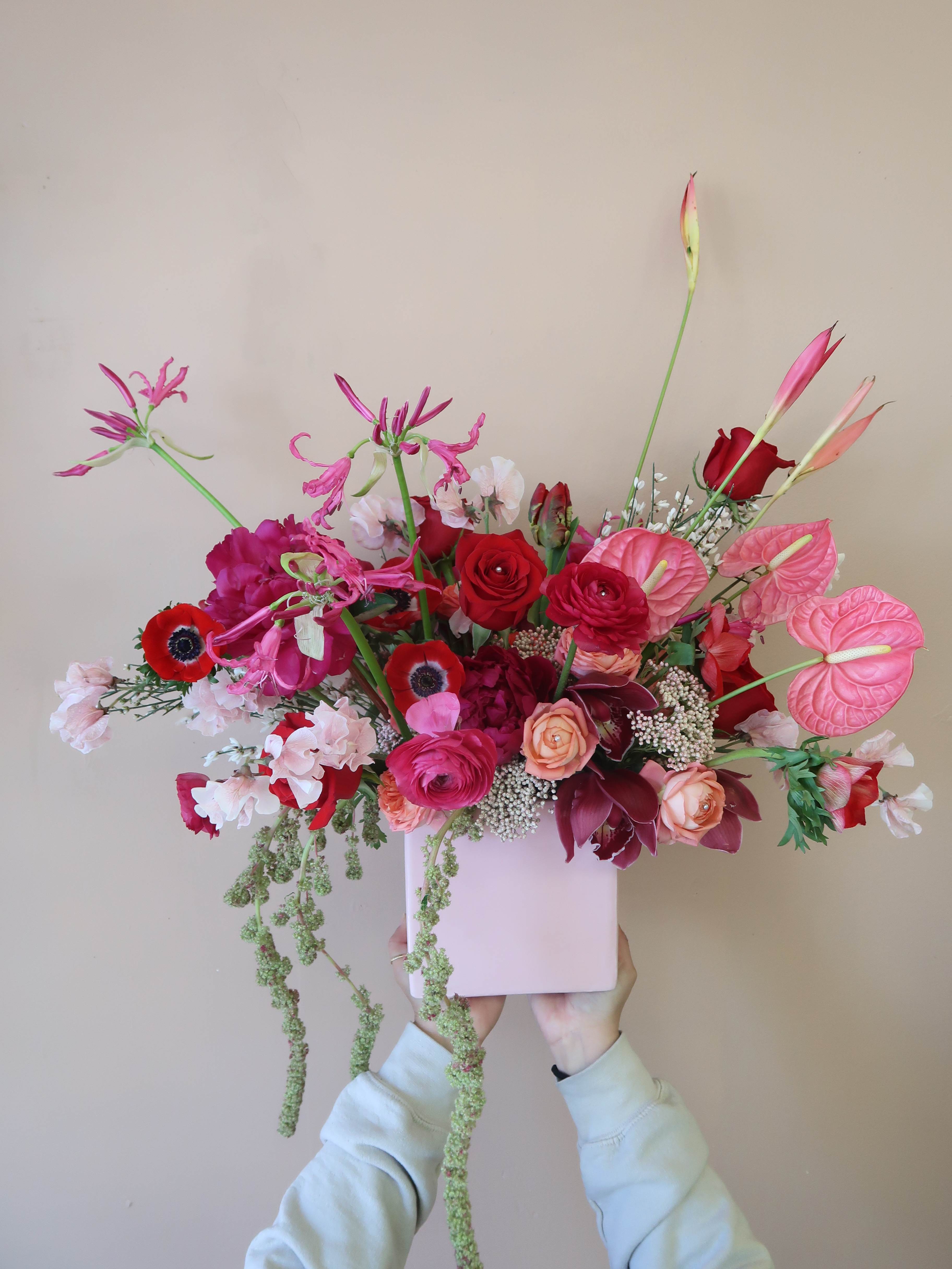 Pink and red floral arrangement in a pale pink box