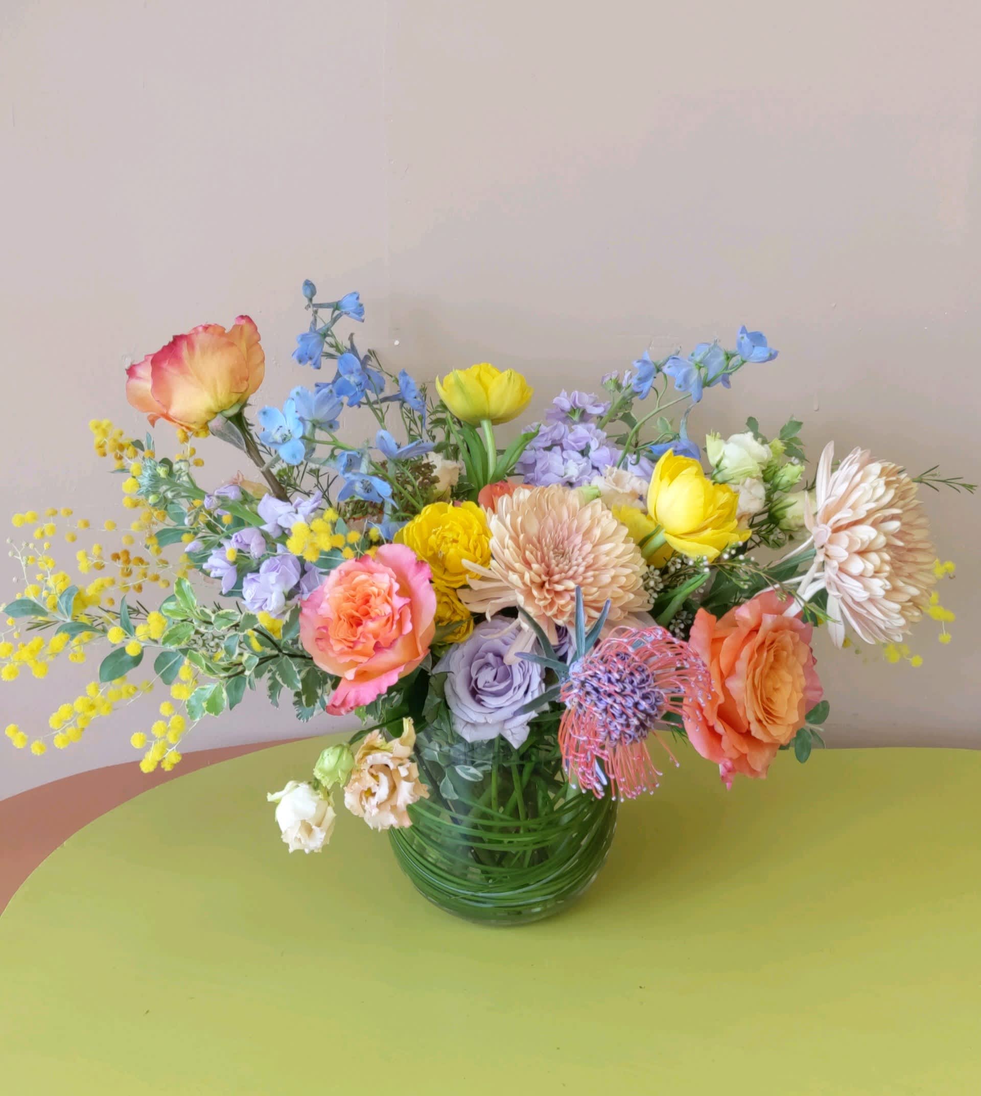 Mixed bouquet of colorful flowers in a glass vase