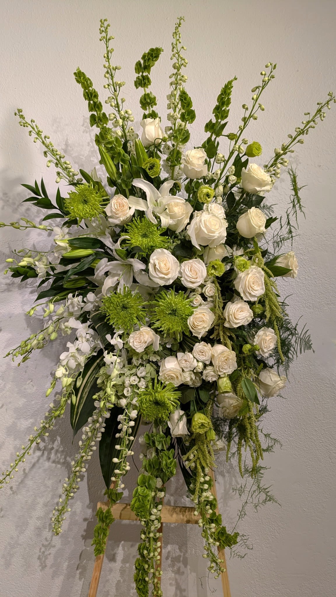 Tall white and green floral spray on an easel