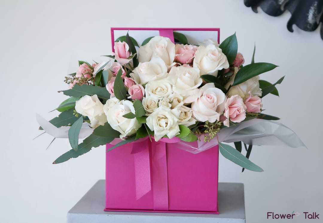 Pink and white rose bouquet in a bright pink gift box