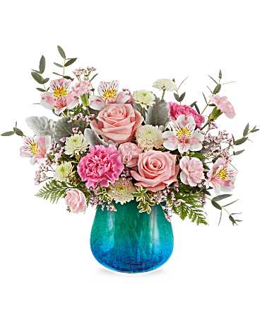 Blue Hues Bouquet - Soft and serene, the Blue Hues Bouquet delights with blush pink blooms and airy whites, artistically arranged in a translucent turquoise glass vase with a crackled finish and dreamy gradient. A beautiful way to share calm and joy. Blue Hues Bouquet features pink roses, pink alstroemeria, pink carnations, miniature pink carnations, white button spray chrysanthemums, pink limonium, dusty miller, parvifolia eucalyptus, leatherleaf fern, and oregonia, presented in a Blue Hues Vase, a translucent glass vase with a turquoise gradient and crackled design. Approximately 17 1/4" W x 13 1/2" H