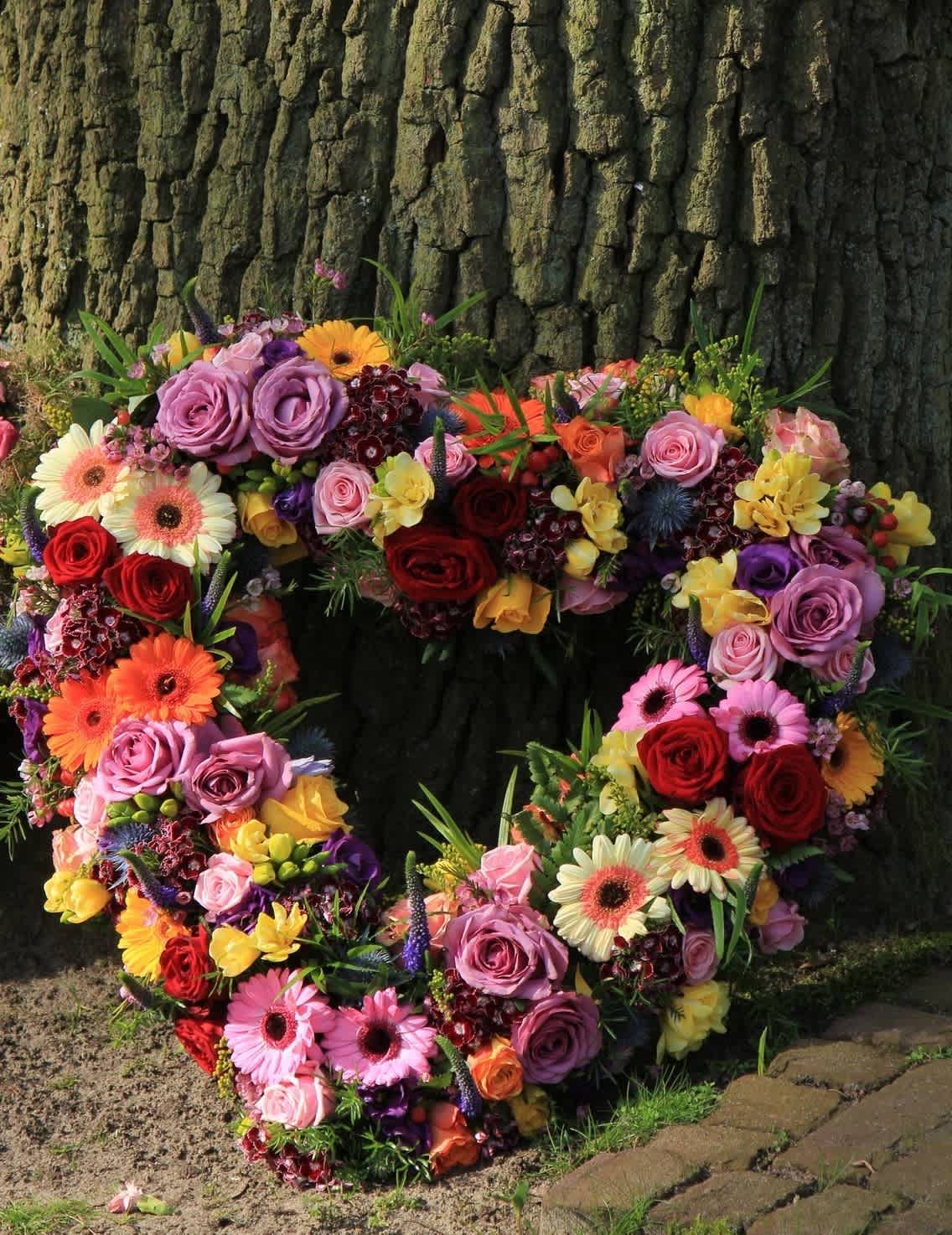 Heart-shaped floral wreath with roses and gerbera daisies