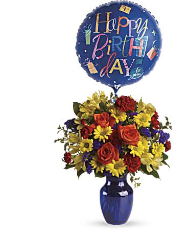 Birthday balloon above a colorful flower arrangement in a blue vase
