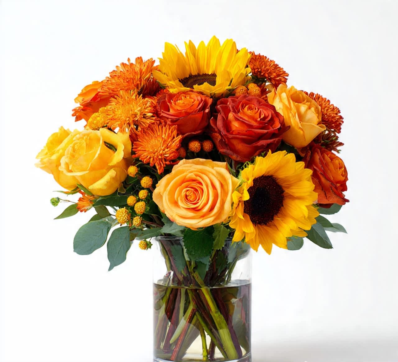 Bouquet of yellow and orange flowers in a clear glass vase