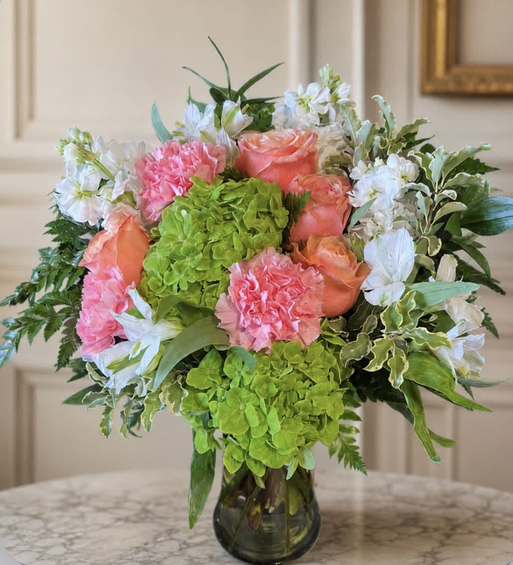 Bouquet of pink and peach flowers in a glass vase