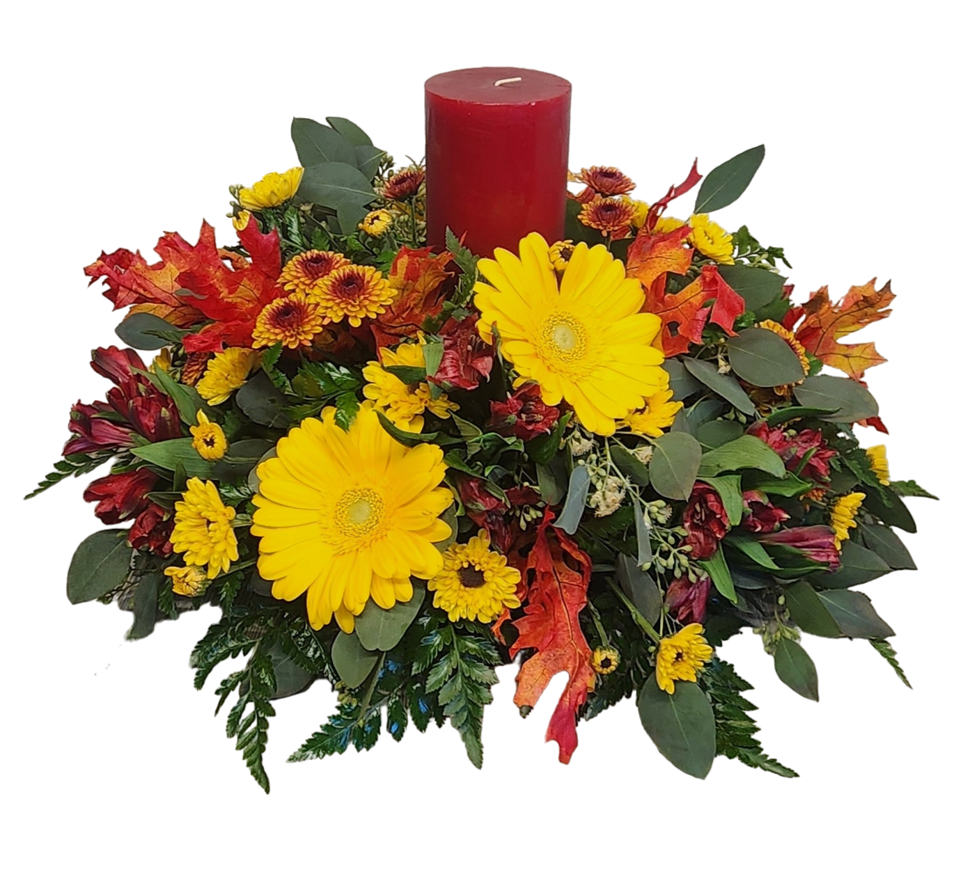 Autumn floral centerpiece with yellow daisies and a red pillar candle