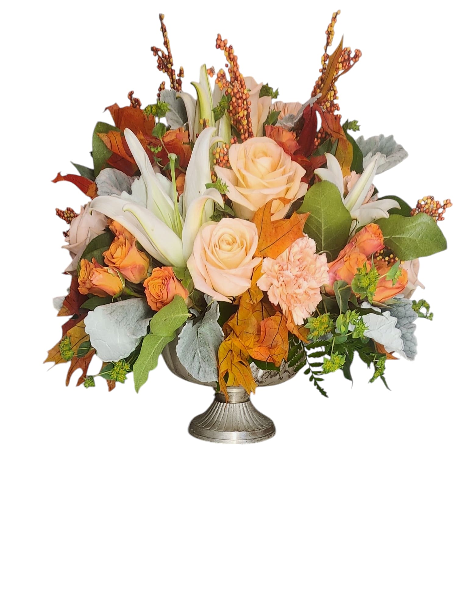 Autumn floral arrangement with peach roses and white lilies in a silver vase
