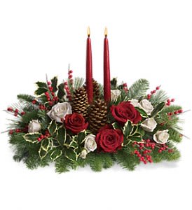 Christmas Glowing - Stunning red and white roses, white spray roses and chrysanthemums plus all of your holiday favorites like pinecones, berries, holly, Christmas greenery and two tall-tapered candles. A brilliant way to send your Christmas wishes in style. Approximately 21" W x 17" H