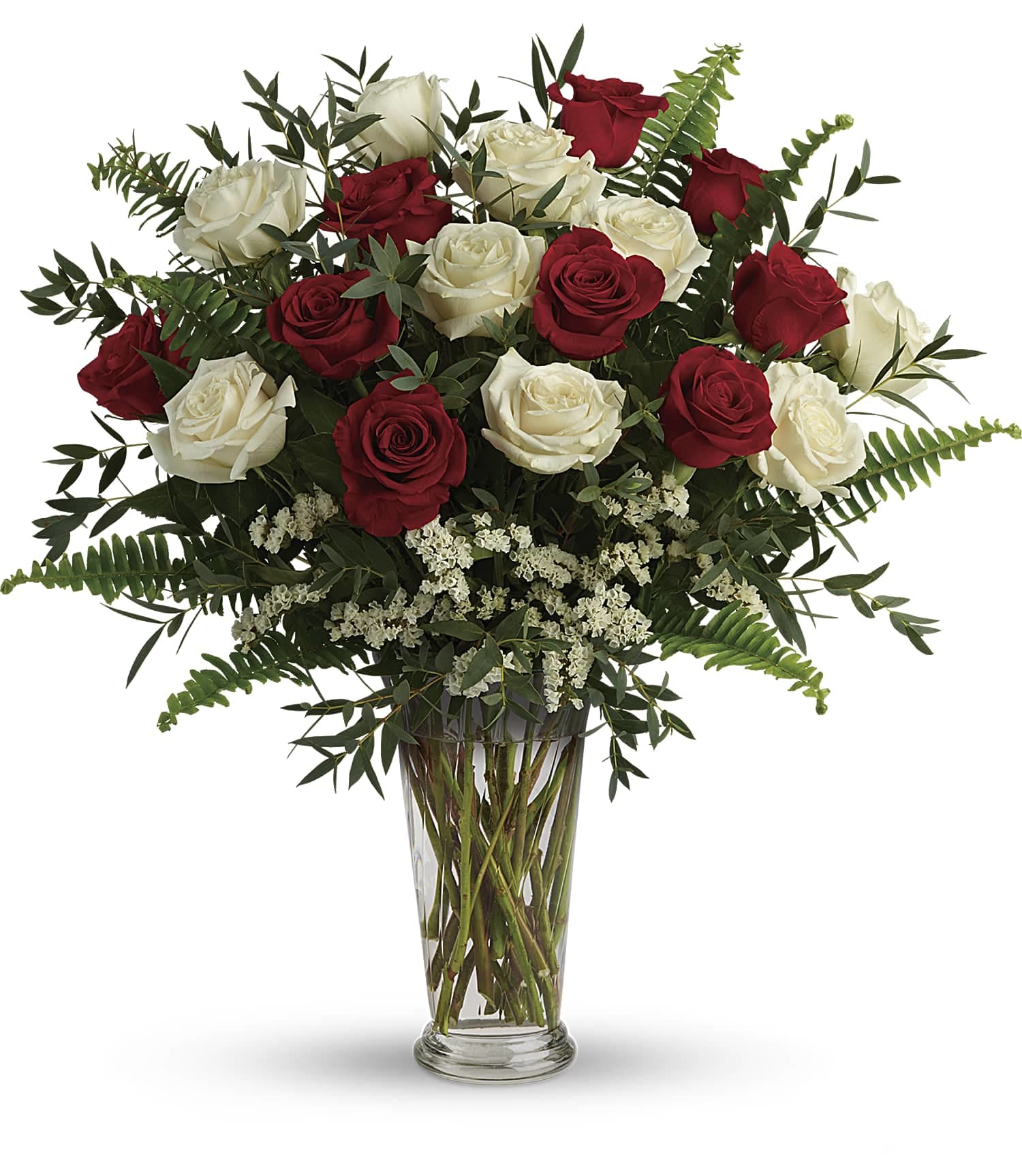 Tall arrangement of red and white roses with filler flowers in a clear glass vase