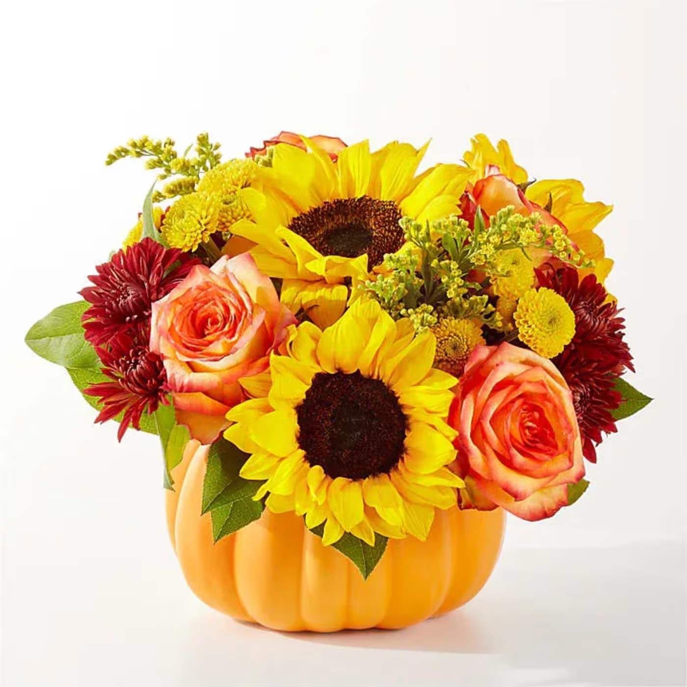 Sunflowers, roses, and mums arranged in a pumpkin-shaped container