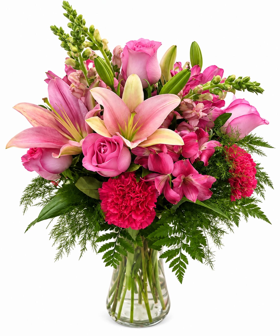 Pink lilies, roses, and carnations in a clear glass vase