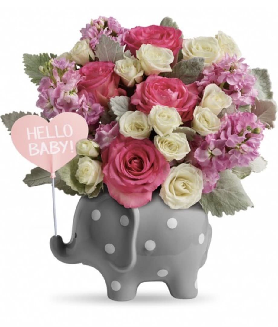Pink and white roses in a gray polka-dot elephant planter with a "Hello Baby!" sign