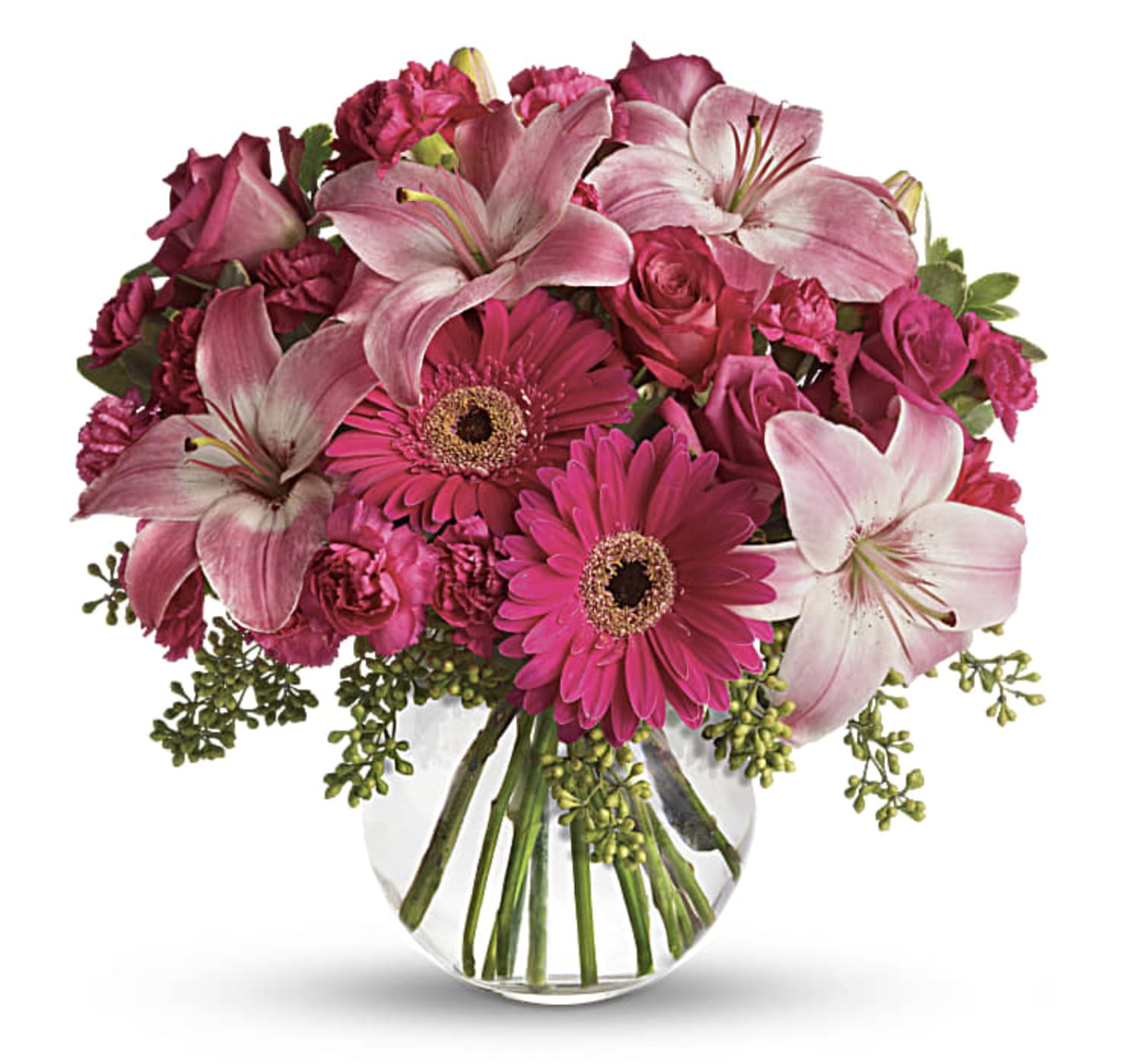 Pink lilies, gerbera daisies, and roses in a clear glass vase