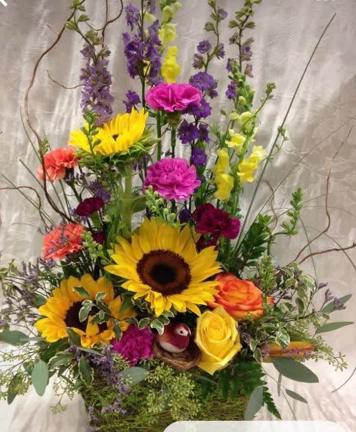 Tall mixed bouquet with sunflowers, roses, and purple blooms