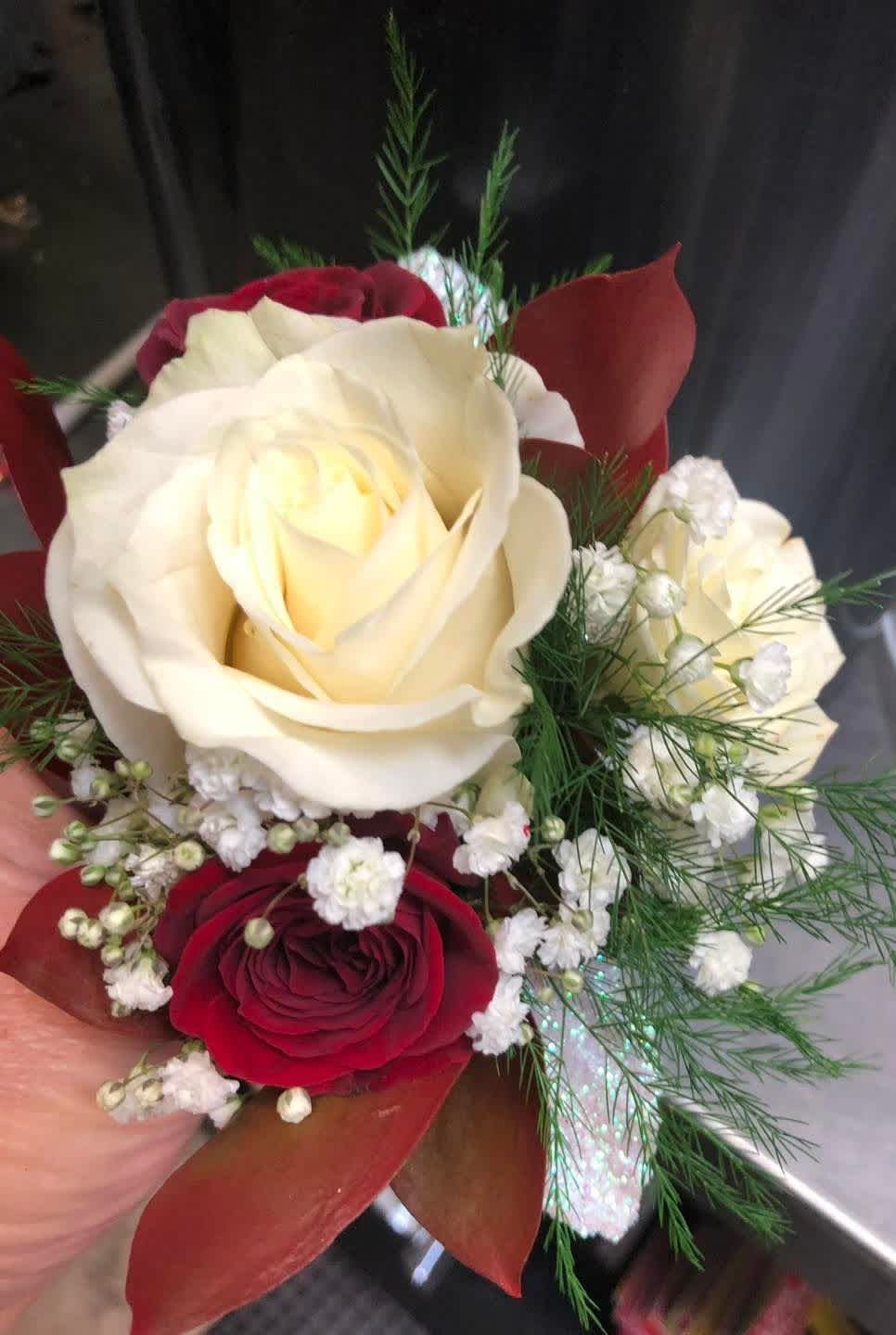 Handheld bouquet of red and white roses with baby's breath
