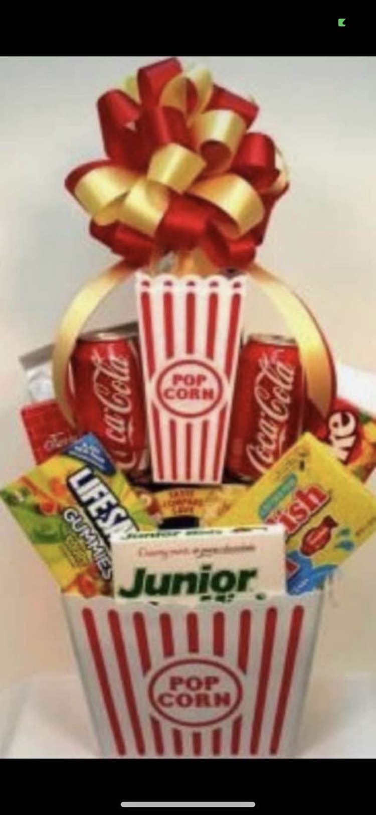 Popcorn bucket gift basket with soda cans and candy