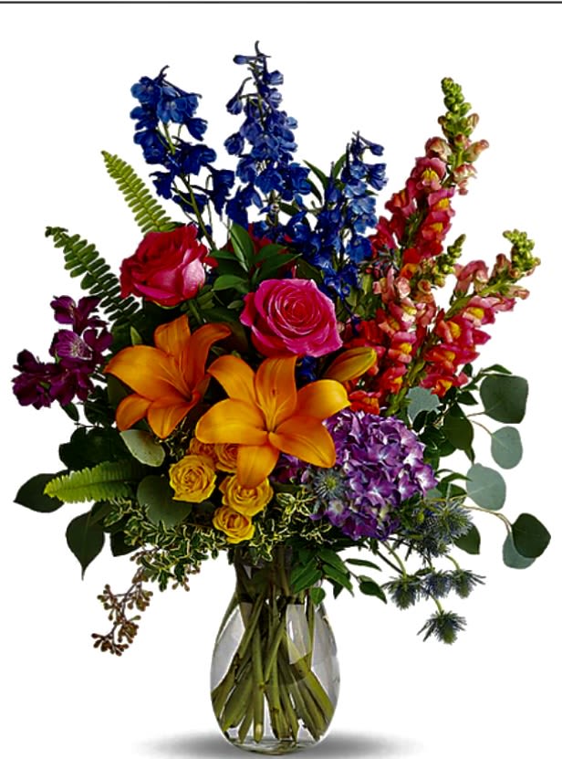 Colorful bouquet of roses, lilies, and mixed blooms in a glass vase