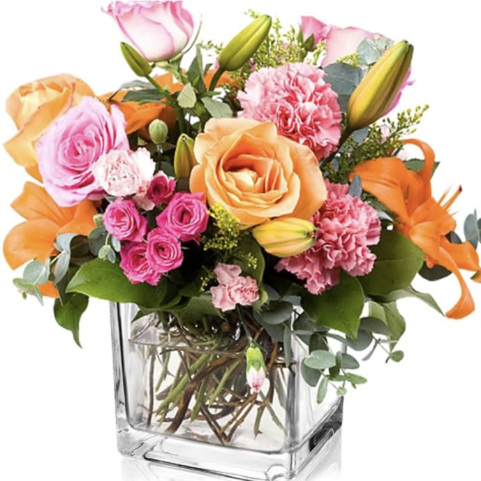 Bouquet of pink and orange flowers in a clear glass vase
