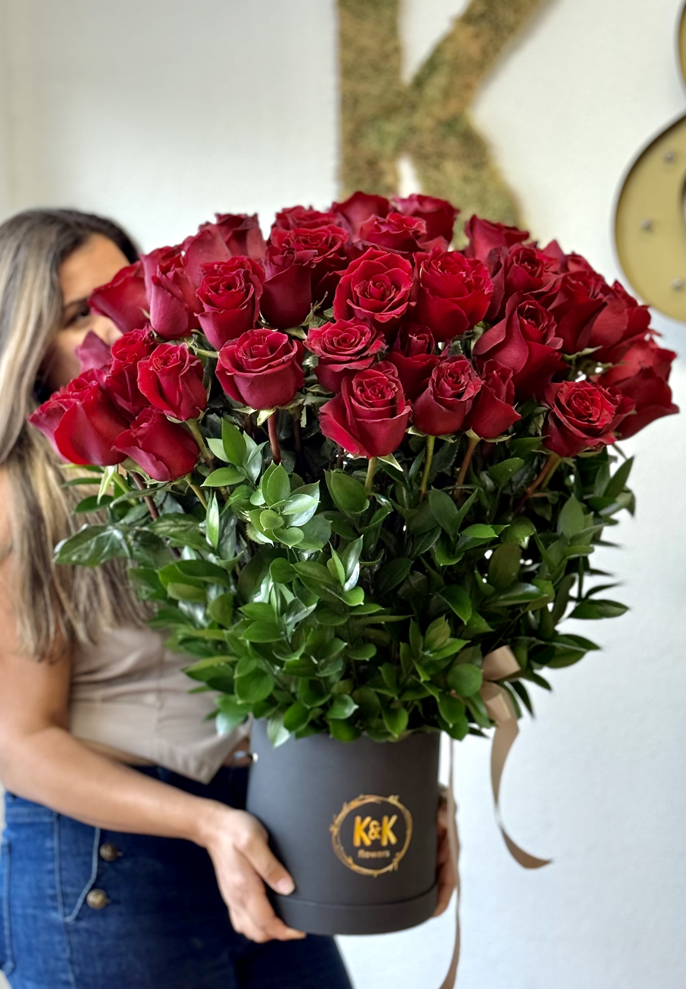 Large bouquet of red roses in a black hat box