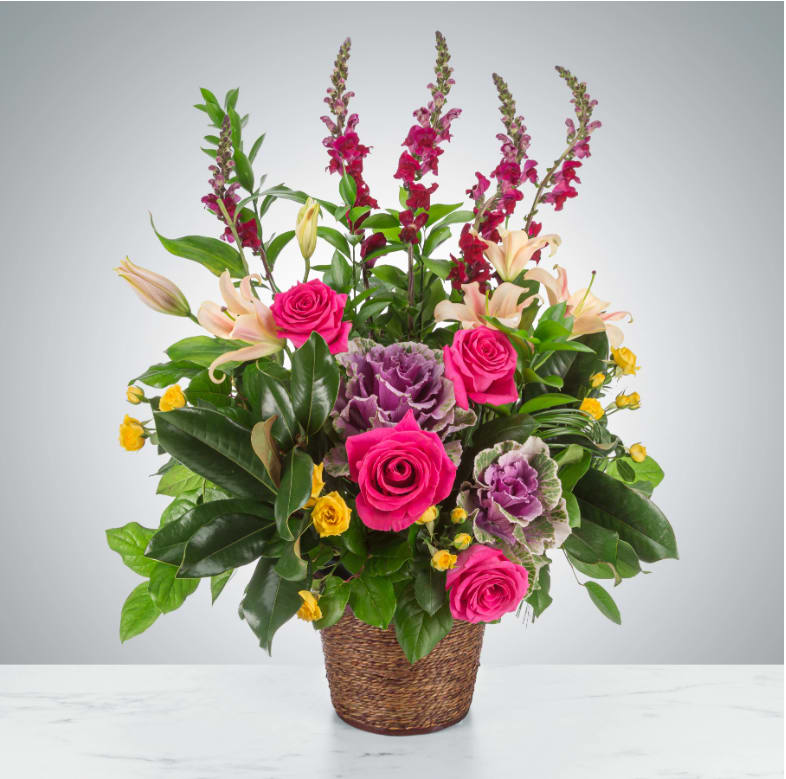 Strength and Silence by BloomNation™ - A multicolored funeral single-sided basket featuring roses, lilies, snapdragons, and more. Suitable for all types of funeral services.